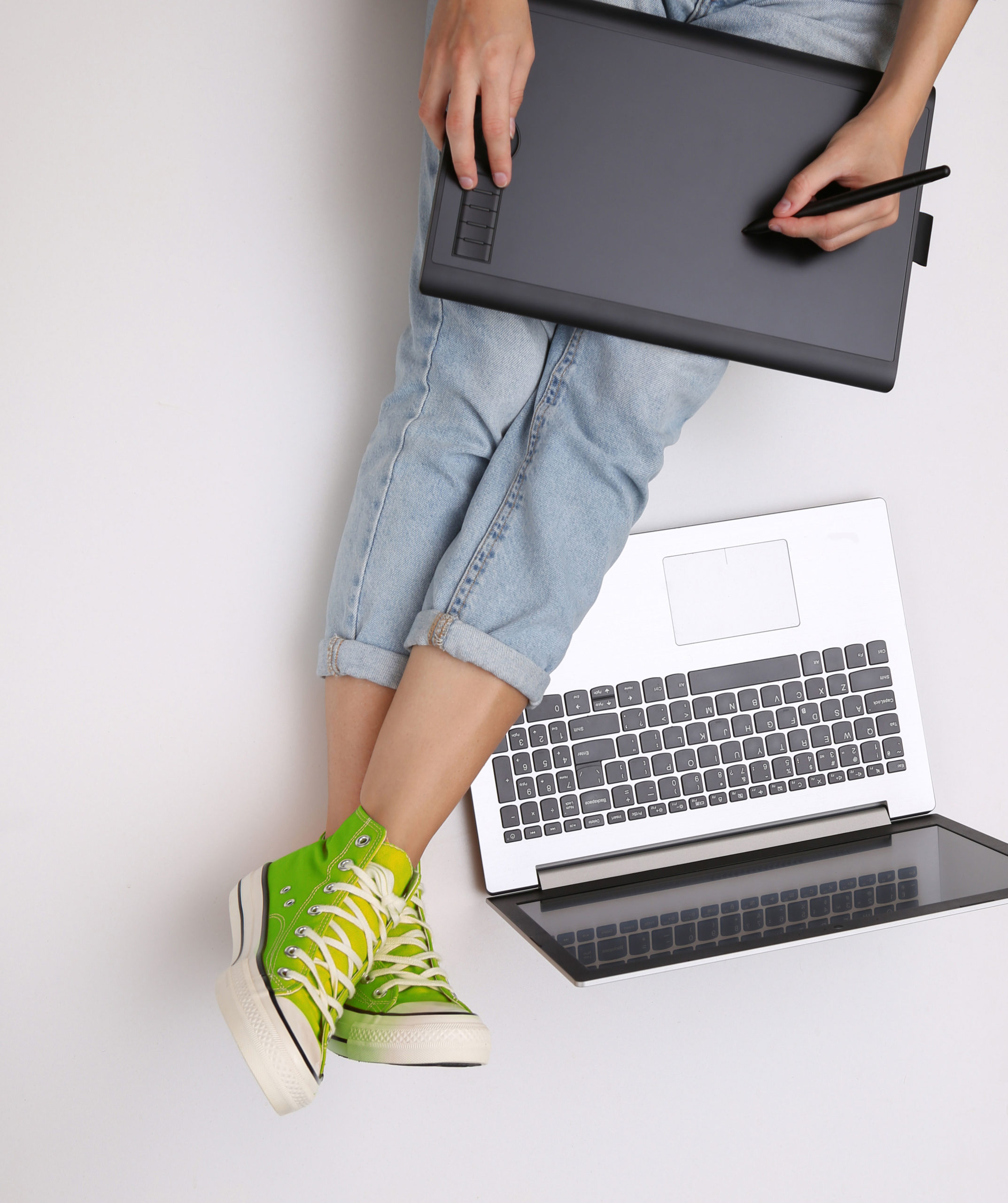 graphic-designer-or-photographer-job-woman-works-with-graphic-tablet-and-laptop-while-sitting-on-a-white-background-freelance-online-work-concept-top-view